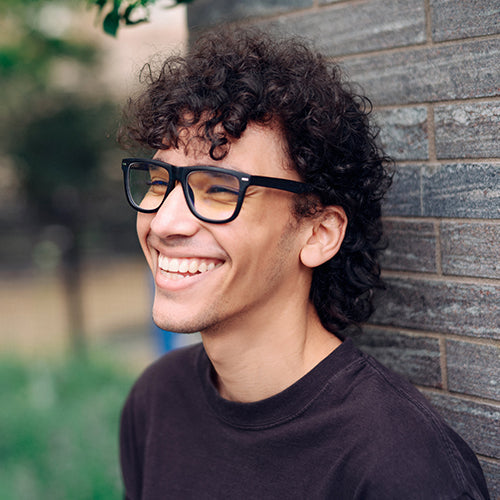 A man wearing black unbreakable reading glasses