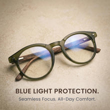 Green reading glasses with blue light protection text on a textured beige background